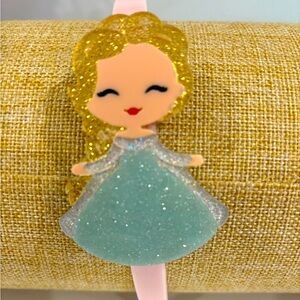 Girls headband with character design on side. Pink headband base.